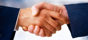 Two disjointed hands, coming out of different suit sleeves, in a handshake